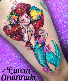 the little mermaid is sitting on top of her tail and has an adorable fish in it's mouth