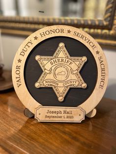 a police badge on top of a wooden table