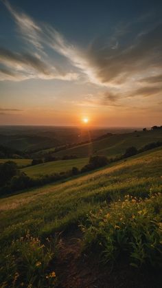 the sun is setting over an open field