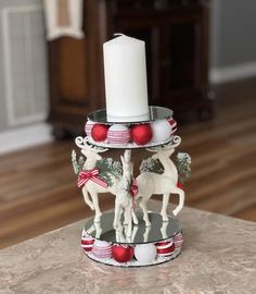 a candle holder is decorated with christmas decorations