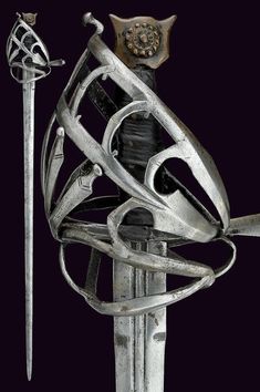 a metal sculpture with two swords and a helmet on top