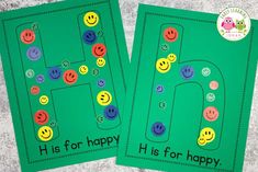 two green cards with smiley faces and the letter h on them, both have different colored buttons