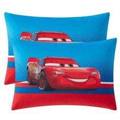 two blue and red pillows with cars on them