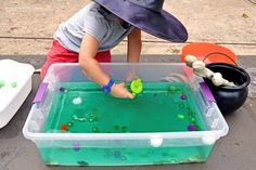 a boy scooping out green water from a transparent bin Sensory Water Play, Toddler Water Table, Sensory Water, Teal Pumpkin, Toddler Sensory, Pumpkin Projects