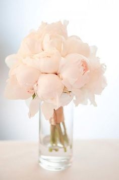 a vase filled with pink flowers sitting on top of a table next to an instagram page