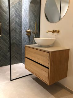 a bathroom with a sink, mirror and shower stall in it's own area