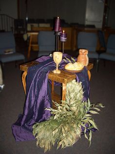 a table topped with a purple cloth covered table