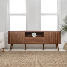 a living room with white walls and wooden furniture