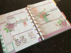 an open planner book sitting on top of a table