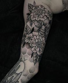 a woman's leg with flowers and birds on it