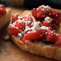 two pieces of bread with tomatoes and cheese on them