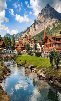 a river running through a lush green hillside