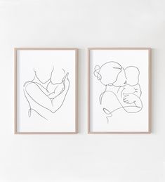 two framed art pieces hang on the wall next to each other, one with a baby in its arms