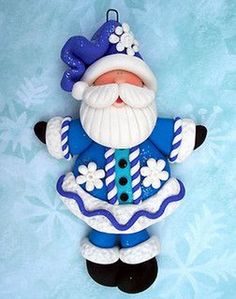 a blue and white santa ornament hanging on a wall