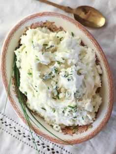 a bowl filled with mashed potatoes on top of a table