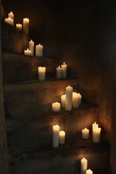 many lit candles are on the stairs