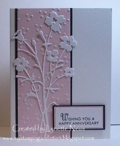 a pink and white card with flowers on it