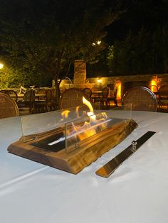 a fire pit sitting on top of a white table