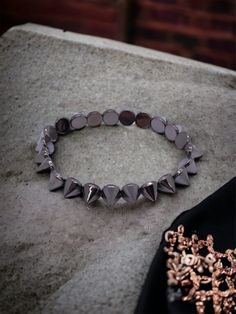 What size is the bracelet? This bracelet is one size fits all - elastic string used.  What material are the beads? -gunmetal spike beads Can I wear it in water? Not recommended.  When was it made? Jewelry is made to order so the beads are always fresh and new! Check us out at: WWW.WOOLANDPEPPERCO.COM WWW.INSTAGRAM.COM/WOOLANDPEPPERCO Gunmetal Jewelry, Glass Heels, Spike Bracelet, Made Jewelry, Gunmetal Grey, Orlando Fl, Black Glitter, In Water, Arm Band