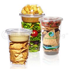 three plastic cups filled with different types of food and salad in each cup are shown