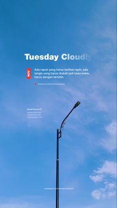 a street light with the words tuesday cloudly on it's side and blue sky in the background