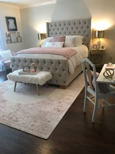 a bedroom with a bed, chair and rug in it's centerpieces