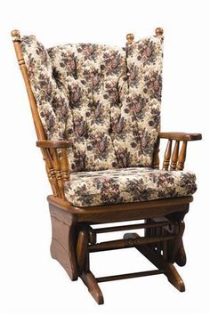 a wooden rocking chair with floral upholstered seat and back cushions on an isolated white background