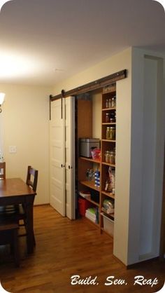 an open pantry door in a dining room