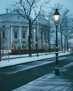 a street light sitting on the side of a snow covered road