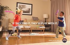 two children are playing with kites in the living room