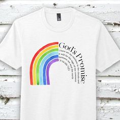 "\"God's Promise Tee - Graphic Tee Christian\" This soft tee is the perfect addition to anyone's wardrobe! The material is a soft poly cotton blend fabric that the authentic design has been printed on to with sublimation. Comfortable and relaxed fit with unisex sizing for adult sizes! The rainbow symbolizes God's Promise to His people! Share this message with others with the God's Promise Tee! Choose from a short sleeve shirt or a dark grey sleeved raglan! God's Promise, God's Rainbow, Rainbow T White Screen Print T-shirt For Pride, White Pre-shrunk T-shirt For Pride, God Rainbow, God's Rainbow, Gods Promise, Rainbow Promise, Rainbow Tshirt, Bleach Dye Shirts, Happy Quotes Inspirational