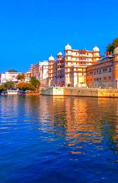 the water is calm and blue with buildings in the background on either side of it