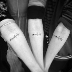 two people with matching tattoos on their arms