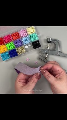 someone is working on some crafting supplies with scissors and paper clips in front of them