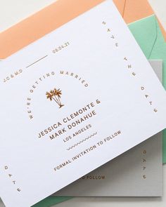 the wedding stationery is laid out on top of each other, including two envelopes