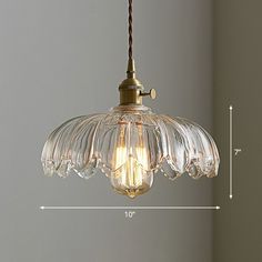 a glass light hanging from a ceiling fixture with measurements for the length and height in front of it