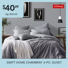 a bed with gray sheets and pillows on it for $ 40 99 or $ 399 00