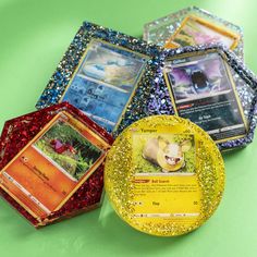 four different types of pokemon cards on a green surface with gold glitter around the edges