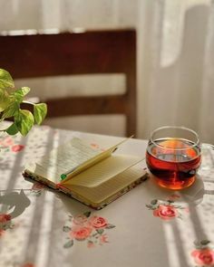 a cup of tea and an open book on a table