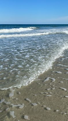 an ocean beach with waves coming in to shore