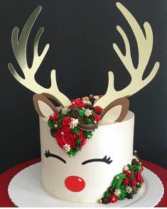 a cake decorated with flowers and reindeer antlers