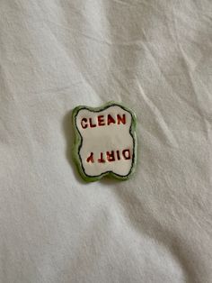 a close up of a cloth with a sign on it that says clean and dishwash