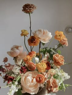 a vase filled with lots of different colored flowers