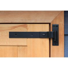 a close up of a wooden door with a black handle on the front and side