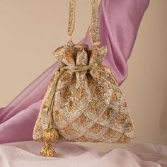 "Golden Silver Sparkle Bead Embroidered Handmade Bag for Woman | Wedding Day Ladies Designer Purse | Art Deco Patchwork Drawstring Bag Purse Package Contents: 1 Size: 10\" x 8\" Designed with the heart, this beautiful Potli or batawa bag are eye catchy and made of premium material. Key Features: Embroidery art work. (bead work). This potli is good match with both Indian and western outfits and are superb for wedding and festive parties. This would be best complement to your designer saree, lenhga or any other kind of dress. This is the combination of traditional and modern embroidery work. This is enough to keep your accessories and all needed essentials and it can be a best gift for any woman." Embellished Potli Bag For Gift, Festive Embellished Potli Bag As Gift, Festival Pearl Embroidered Pouch Shoulder Bag, Beaded Pouch Potli Bag For Gift, Beaded Pouch Potli Bag As Gift, Beaded Potli Bag Pouch For Gifts, Beaded Potli Bag Gift Pouch, Beaded Potli Bag Gift, Festive Beaded Evening Bag As Gift