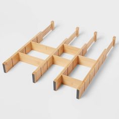 four pieces of wood sitting on top of each other in the shape of three squares