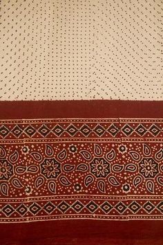 two red and white bedspreads on top of each other