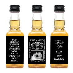 three bottles of personalized whiskey with labels on the front and back, each containing an image of a couple kissing