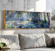 a painting hanging on the wall above a couch in a living room with white furniture