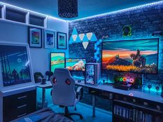 a gaming room with multiple monitors and games on the walls, along with an office chair